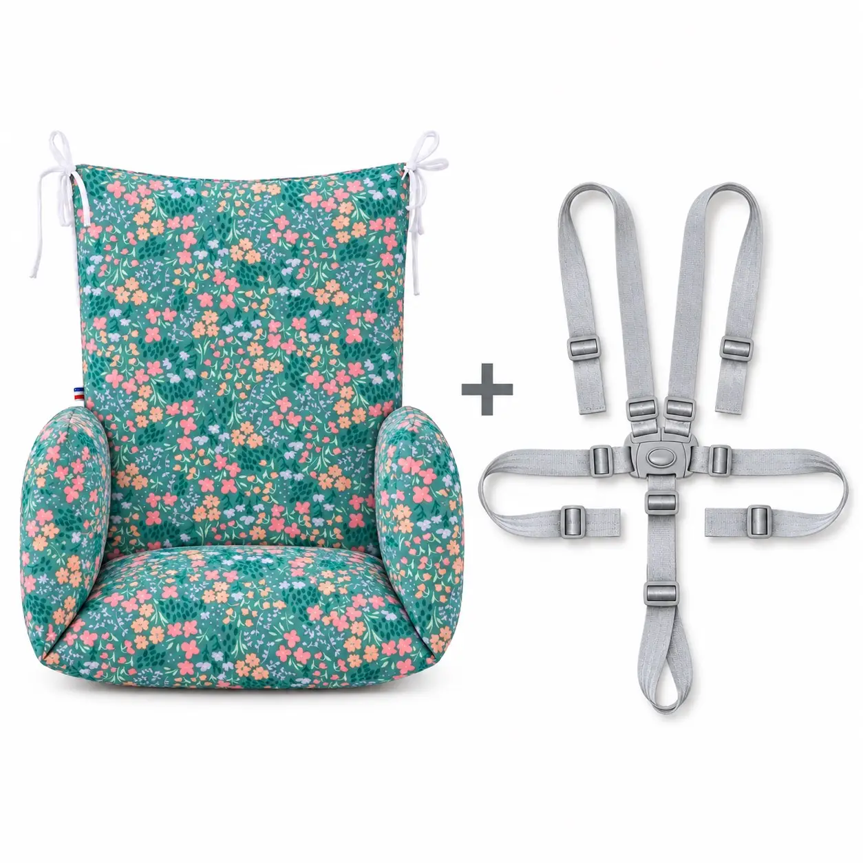 Réducteur chaise haute bois – Liberty 3 Coussin de chaise haute universel Liberty fleuri, présenté de face à côté d’un harnais gris à cinq points.