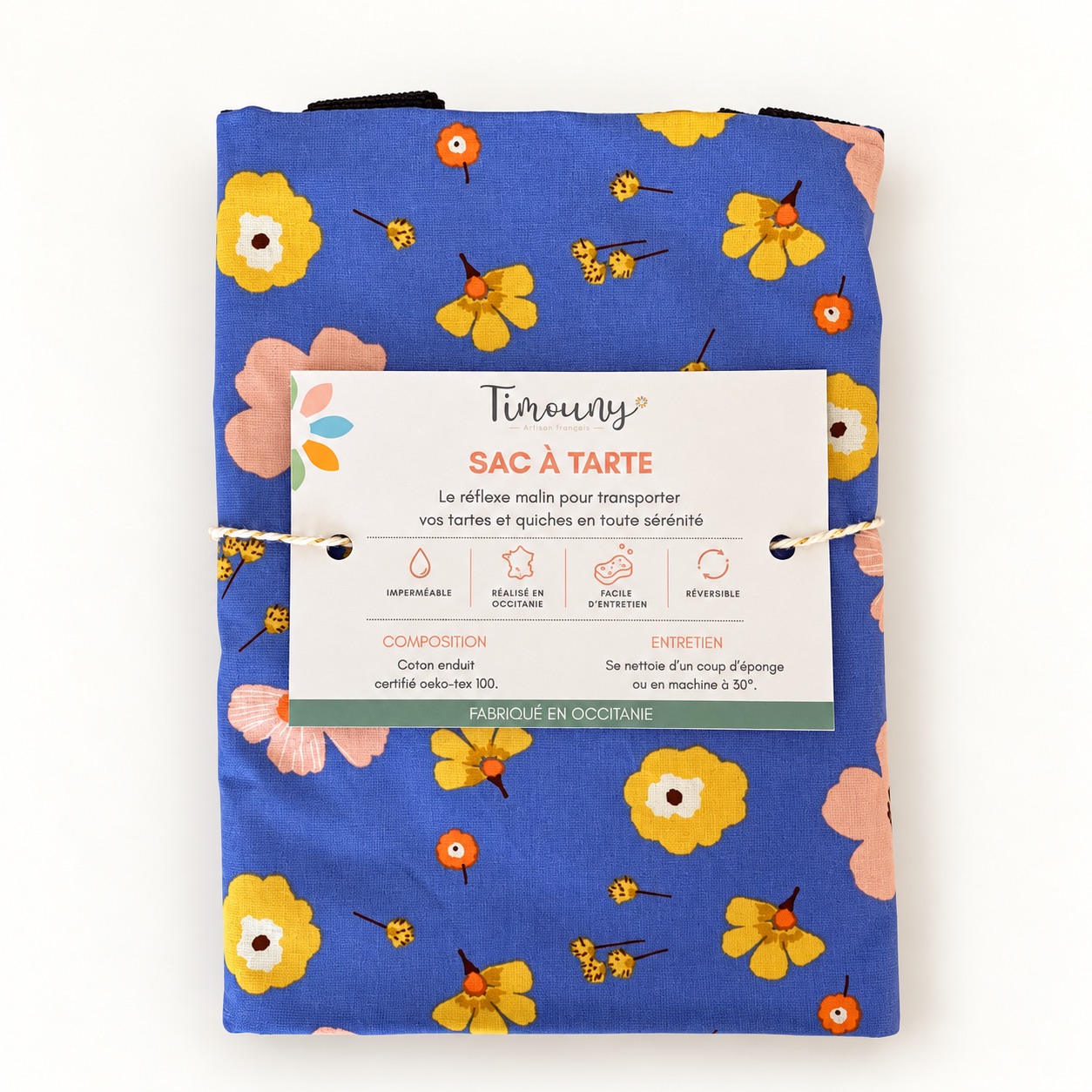 Sac à tarte fabriqué en France Azalée – Fleuri bleu, imperméable et réversible 1 ac à tarte bleu fleuri Timouny plié avec son bandeau de présentation